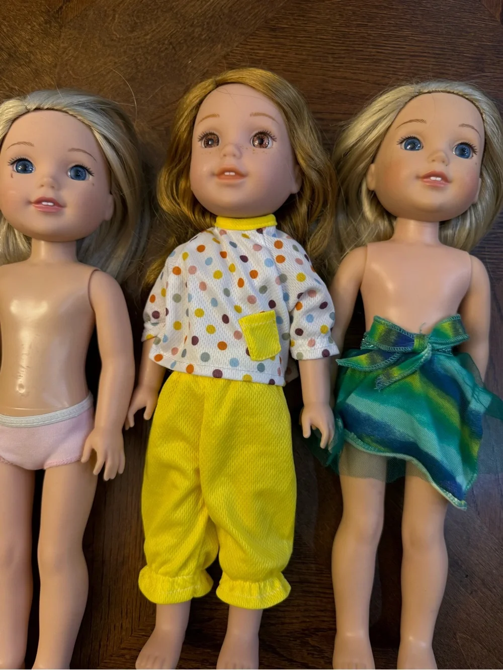 3 American girl-wellie wisher dolls.